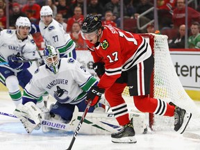 Dylan Strome #17 of the Chicago Blackhawks tries to get off a shot against Jacob Markstrom #25 of the Vancouver Canucks at the United Center on February 7, 2019 in Chicago, Illinois.