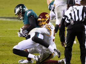 Eagles quarterback Nate Sudfeld gets taken down by Washington’s Montez Sweat on Sunday night.