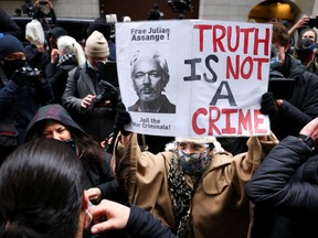 People celebrate after a judge ruled that WikiLeaks founder Julian Assange should not be extradited to the United States, outside the Old Bailey, the Central Criminal Court, in London, Britain, January 4, 2021.