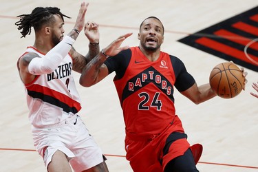 Jan 11, 2021; Portland, Oregon, USA; Toronto Raptors shooting guard Norman Powell (24) drives to the basket while defended by Portland Trail Blazers shooting guard Gary Trent Jr. (2) during the second half at Moda Center. Mandatory Credit: Soobum Im-USA TODAY Sports ORG XMIT: IMAGN-443636