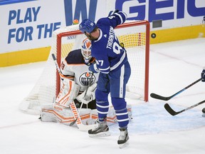 Toronto Maple Leafs forward Joe Thornton (97) deflects the puck and Edmonton Oilers goalie Mikko Koskinen (19) makes a save in the first period at Scotiabank Arena.
