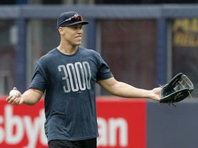 Aaron Judge of the New York Yankees works out on the field prior to a game against the Boston Red Sox at Yankee Stadium on May 30, 2019.