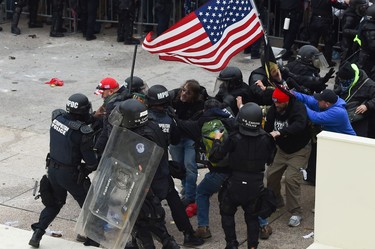 Trump supporters clash with police and security forces as they storm the US Capitol in Washington D.C on January 6, 2021. (Photo by ROBERTO SCHMIDT/AFP via Getty Images)