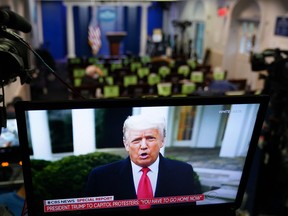 U.S. President Donald Trump is seen on TV from a video message released on Twitter, seen in an empty Brady Briefing Room at the White House in Washington, D.C. on January 6, 2020.