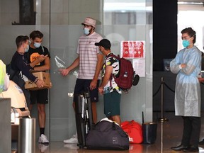 Tennis players leave their hotel for a practice session in Melbourne, on Wednesday, Jan. 20, 2021, as some players are allowed to train while serving quarantine for two weeks ahead of the Australian Open.