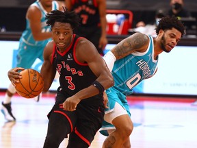 Toronto Raptors forward OG Anunoby (3) and Charlotte Hornets forward Miles Bridges (0) battle for a ball during the second half at Amalie Arena.