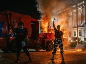 Demonstrators chant in front of a burning truck on August 24, 2020 in Kenosha, Wisconsin. This