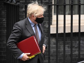 Prime Minister Boris Johnson leaves Downing Street for PMQ's on January 27, 2021 in London.
