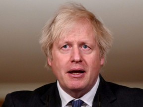 British Prime Minister Boris Johnson attends a coronavirus news conference at 10 Downing Street, London, Friday, Jan. 22, 2021.