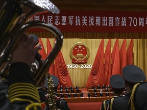 Chinese President Xi Jinping, middle, and senior members of the government stand as a the People's Liberation Army Band plays the national anthem at a ceremony marking the 70th anniversary of China's entry into the Korean War, on October 23, 2020 at the Great Hall of the People in Beijing, China.