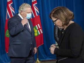 Ontario Premier Doug Ford walks back to the podium after Associate Medical Officer of Health Dr. Barbara Jaffe finishes speaking at the daily briefing at Queen’s Park in Toronto on Friday, January 8, 2021.