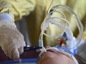A health-care worker cares for an intubated COVID-19 patient at  Humber River Hospital in Toronto on Wednesday, December 9, 2020.