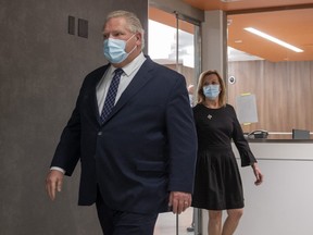 Ontario Premier Doug Ford and Health Minister Christine Elliot walk out after being given a tour of a digital Intensive Care Unit room at Cortellucci Vaughan Hospital in Vaughan, Ontario on Monday, January 18, 2021.