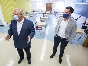 Ontario Premier Doug Ford, left, and Education Minister Stephen Lecce take a tour of Kensington Community School in Toronto on September 1, 2020.