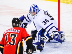 Leafs goalie Jack Campbell makes a save against Flames winger Johnny Gaudreau on Sunday. Campbell suffered a knee injury in the game and is out for weeks. GETTY IMAGES