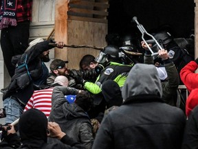 Supporters of U.S. President Donald Trump battle with police at the west entrance of the Capitol building during a "Stop the Steal" protest in Washington, D.C., Jan. 6, 2021.