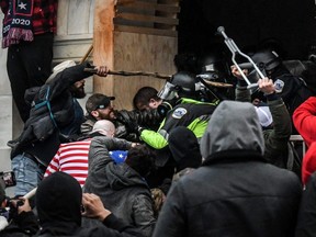 Supporters of U.S. President Donald Trump battle with police at the west entrance of the Capitol building during a "Stop the Steal" protest in Washington, D.C., Jan. 6, 2021.