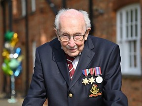 British World War II veteran Captain Tom Moore poses doing a lap of his garden in the village of Marston Moretaine, 80 km north of London, April 16, 2020.