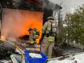 Halton firefighters work to extinguish a fire in Acton on Tuesday, Jan. 26, 2021.