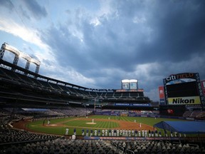 The Marlins and Mets players stand in the field in protest before walking out of a game at Citi Field in New York City, Aug. 27, 2020.