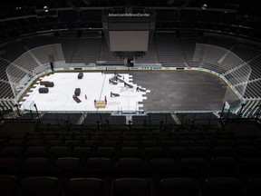Crews cover the ice at American Airlines Center in Dallas, in March 2020. The Stars announced a COVID outbreak among players and staff on Friday, delaying the start of their season. AP FILES