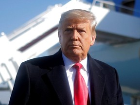 U.S. President Donald Trump looks on as he speaks to the media before boarding Air Force One to depart Washington to visit the U.S.-Mexico border wall in Texas, at Joint Base Andrews in Maryland, Tuesday, Jan. 12, 2021.