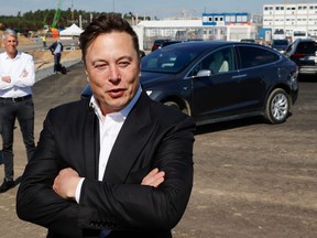 In this file photo, Tesla CEO Elon Musk talks to media as he arrives to visit the construction site of the future U.S. electric car giant Tesla in Gruenheide near Berlin on Sept. 3, 2020.