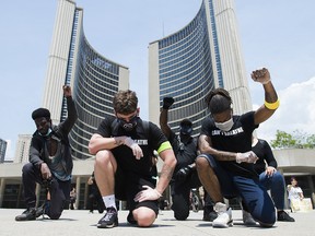 People protest in solidarity with the George Floyd protests and honouring black lives that have been lost at the hands of police across the United States in Toronto on Friday, June 5, 2020.
