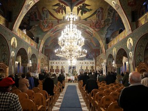 Faithfuls attend a service for Orthodox Epiphany celebrations, after Holy Synod rejected government decision to close churches on Epiphany day, amid the coronavirus disease pandemic, in Athens, Greece, January 6, 2021.