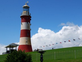 Smeaton’s Tower situated on Plymouth Hoe, Plymouth, Devon, England along with a series of international flags.
