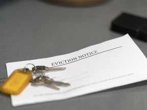 House keys sitting on an eviction notice received in the mail.