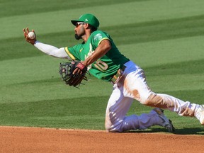 Marcus Semien juggles an infield hit during a game last season with the Oakland Athletics. The free agent has signed a one-year deal with the Blue Jays.