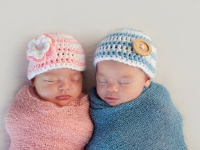 A sleeping baby girl and boy.