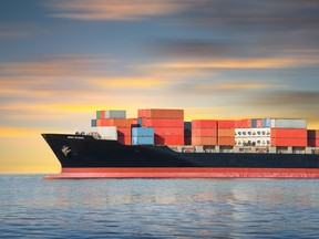 Cargo ship and cargo container in sea with sky background.