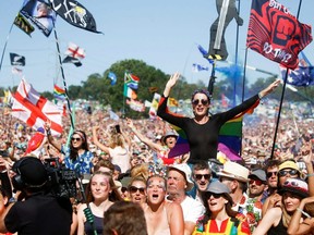 Revellers watch Kylie Minougue perform during the Glastonbury Festival in Somerset, England, June 30, 2019.