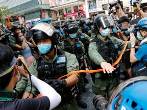 Riot police disperse pro-democracy protesters during a demonstration opposing postponed elections, in Hong Kong, China September 6, 2020.