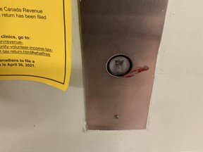 Blood on the elevator button on the 9th floor of an apartment building at 2495 Eglinton Ave. E. after a Minnesota man was fatally stabbed Jan. 13, 2021.