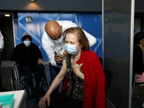 A woman receives a vaccination against the coronavirus disease (COVID-19) at a vaccination centre in Jerusalem, Jan. 3, 2021.