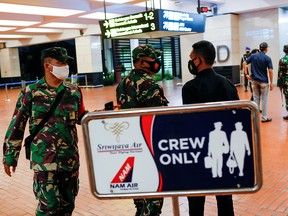 Indonesian soldiers are seen at Soekarno-Hatta International Airport after Sriwijaya Air plane lost contact after taking off, in Tangerang, Indonesia, January 9, 2021.