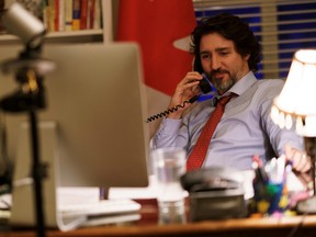Prime Minister Justin Trudeau speaks on the phone with U.S. President Joe Biden, who made the first call to a foreign leader following his inauguration, in Ottawa, Jan. 22, 2021.