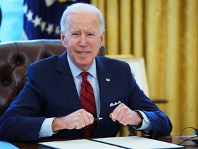 U.S. President Joe Biden prepares to sign executive orders on affordable healthcare in the Oval Office of the White House in Washington, D.C., Thursday, Jan. 28, 2021.