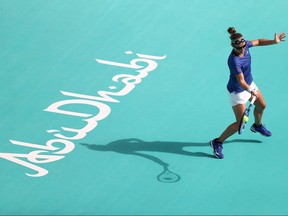 Kirsten Flipkens of Belgium plays a forehand against Sofia Kenin of United States during her Women's Singles match on Day 3 of the Abu Dhabi WTA Women's Tennis Open at Zayed Sports City on Jan. 8, 2021 in Abu Dhabi, United Arab Emirates.