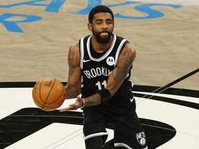 Nets guard Kyrie Irving dribbles the ball against the Jazz  during first half NBA action at Barclays Center in Brooklyn, N.Y., Jan. 5, 2021.