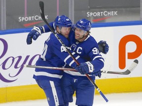 Maple Leafs defenceman Morgan Rielly (44) celebrates his overtime goal with John Tavares, who set up the game-winner, on Wednesday at an empty Scotiabank Arena.