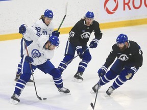 Toronto Maple Leafs John Tavares (91) cuts along the blue line and drops a pass through his legs to William Nylander RW (back) at practice in Toronto on Tuesday.