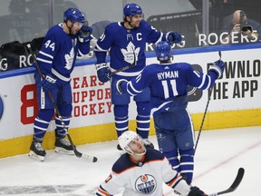 John Tavares  celebrates his third-period power-play goal with teammates Morgan Rielly and Zach Hyman on Friday January 22, 2021 at Scotiabank Arena.
