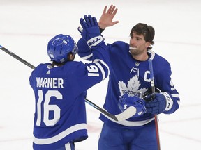 Toronto Maple Leafs John Tavares C (91) congratulates teammate Mitch Marner after their 4-2 win over the Oilers in Toronto on Friday January 22, 2021.