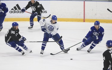 Toronto Maple Leafs Ilya Mikheyev RW (65) pushes the puck past Rasmus Sandin D (38) and Alexander Barabanov LW (94) at practice in Toronto on Tuesday January 12, 2021. Jack Boland/Toronto Sun/Postmedia Network