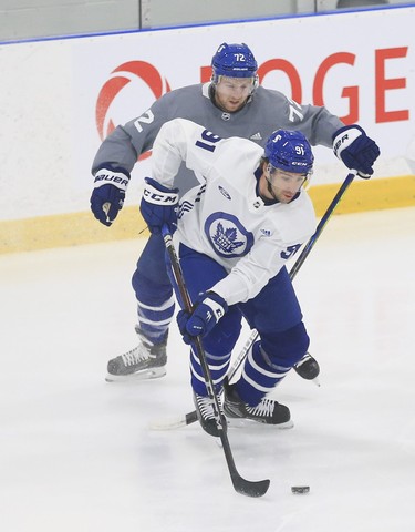 Toronto Maple Leafs John Tavares C (91) tries to get away from Travis Boyd RW (72) at practice in Toronto on Tuesday January 12, 2021. Jack Boland/Toronto Sun/Postmedia Network