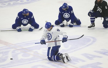 Maple Leafs' John Tavares (centre) does some warm-down twists at centre ice during practice in Toronto on Tuesday January, 12, 2021.